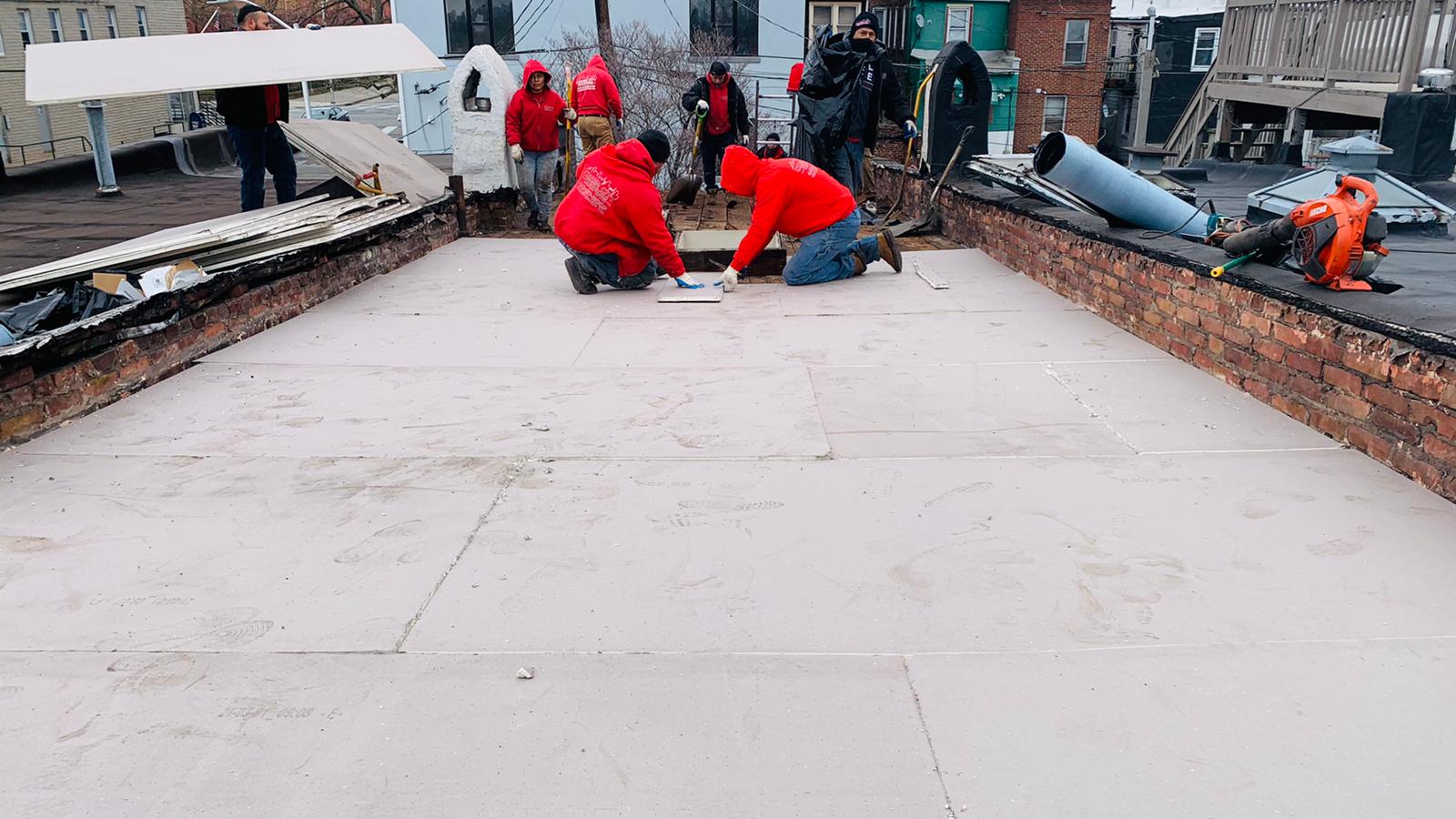 Charm City Roofing Crew Installs Insulation on Flat Roof