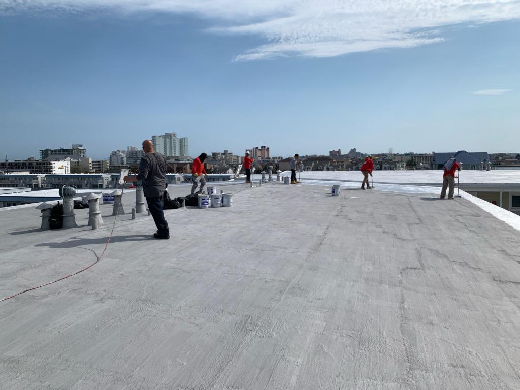 Charm City Roofing rolls on L.A.M Roofing onto a commercial building in Ocean City, MD