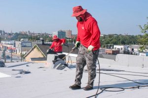 Charm City Roofing Technician Install Commercial Roof in Baltimore, MD