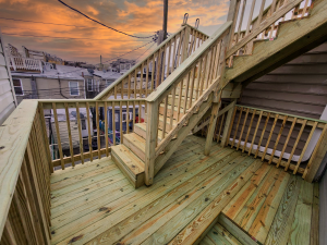 Landing area and stairs up to the top level of a Baltimore, MD rooftop deck.